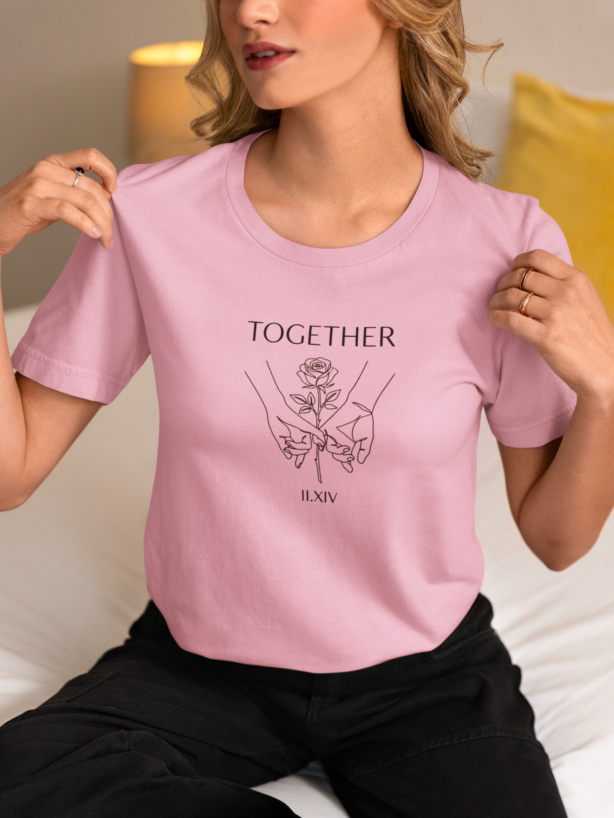 Grey Comfort Colors t-shirt with minimalist black line art of two hands holding a rose. "TOGETHER" text above and "II.XIV" Roman numerals below. Valentine's Day couple graphic tee.